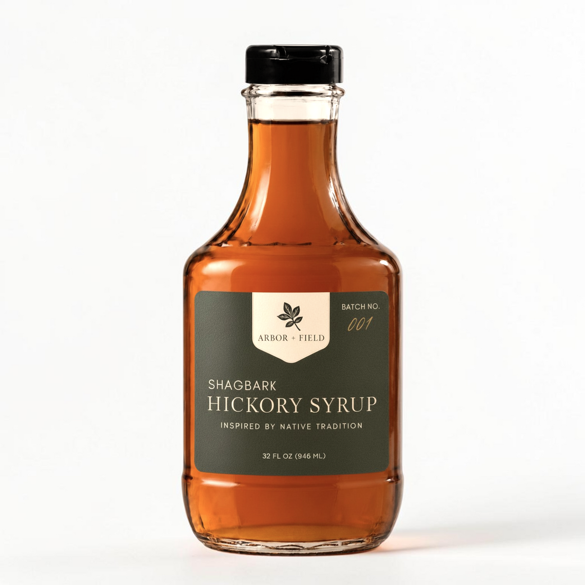 Shagbark Hickory Syrup 32 oz decanter bottle with green and cream Arbor and Field label on the front, a gold wax-dipped cap, and a handwritten gold batch number. Clean white background, premium look and feel.